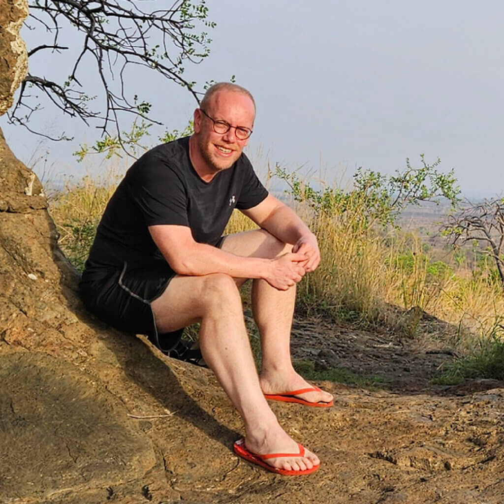 Ebonjalo Tours – East Africa Safari Tours Jan Boelo of Ebonjalo Tours sitting at Napadet Cave also Called the Elephant cave in Pian Upe Uganda