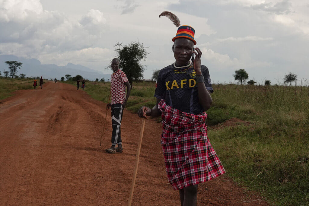 Karamoja Uganda: History, People and Culture of the Warrior Nomads Karamajong man on the phone in modern day Karamoja Uganda